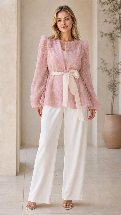 Front view of woman wearing dusty pink sequin belted evening blouse jacket