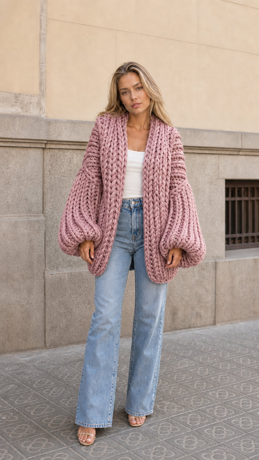 Front view of woman wearing dusty pink chunky knit open front oversized cardigan