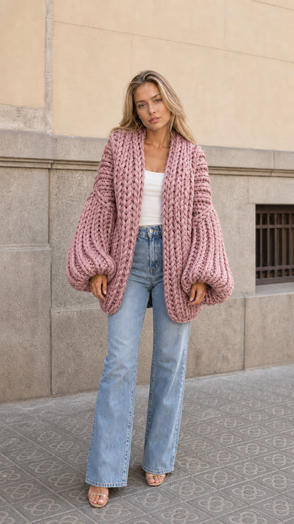 Front view of woman wearing dusty pink chunky knit open front oversized cardigan
