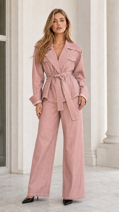 Model wearing dusty pink contrast stitch belted denim jacket and wide-leg pants set