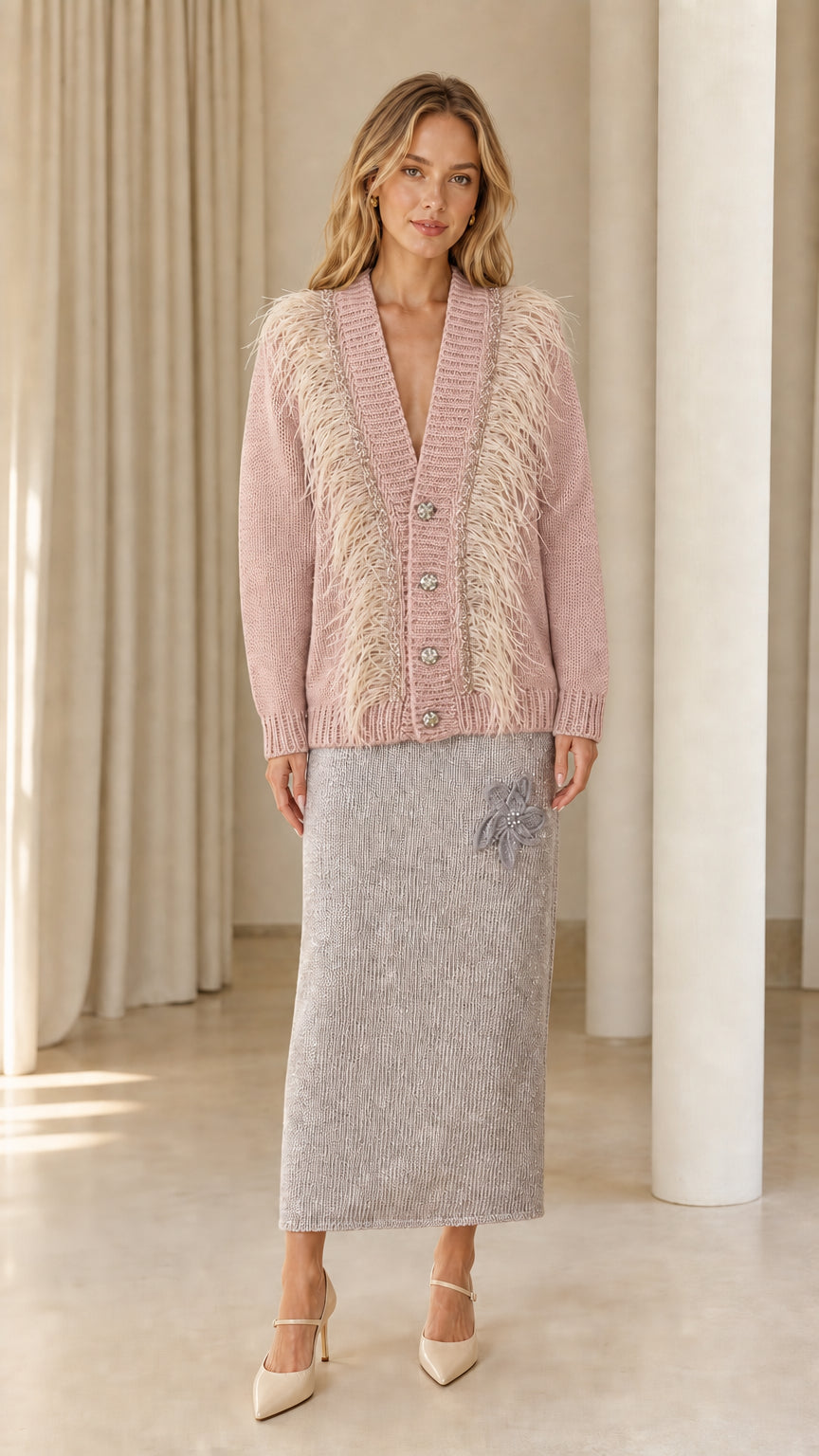 Front view of woman wearing dusty pink feather trim cardigan sweater