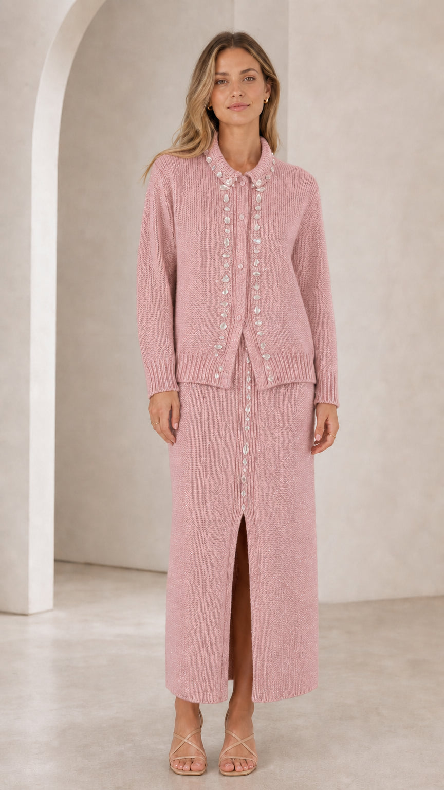 Front view of woman wearing dusty pink rhinestone-embellished knit cardigan and maxi skirt set