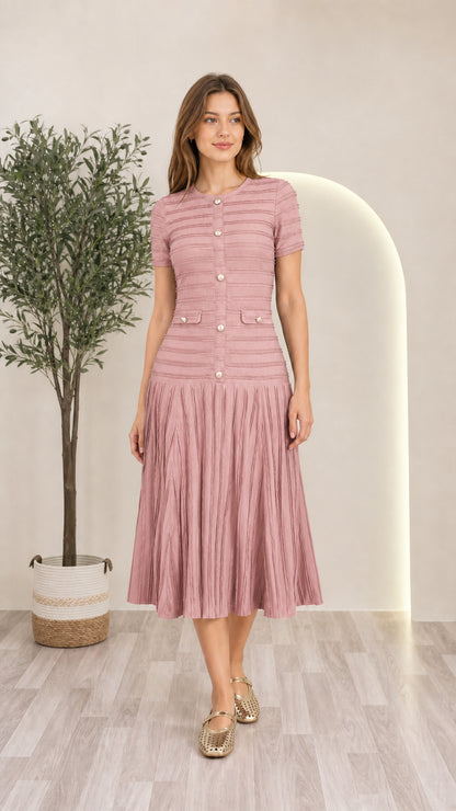 Model wearing dusty pink short sleeve pleated knit midi dress