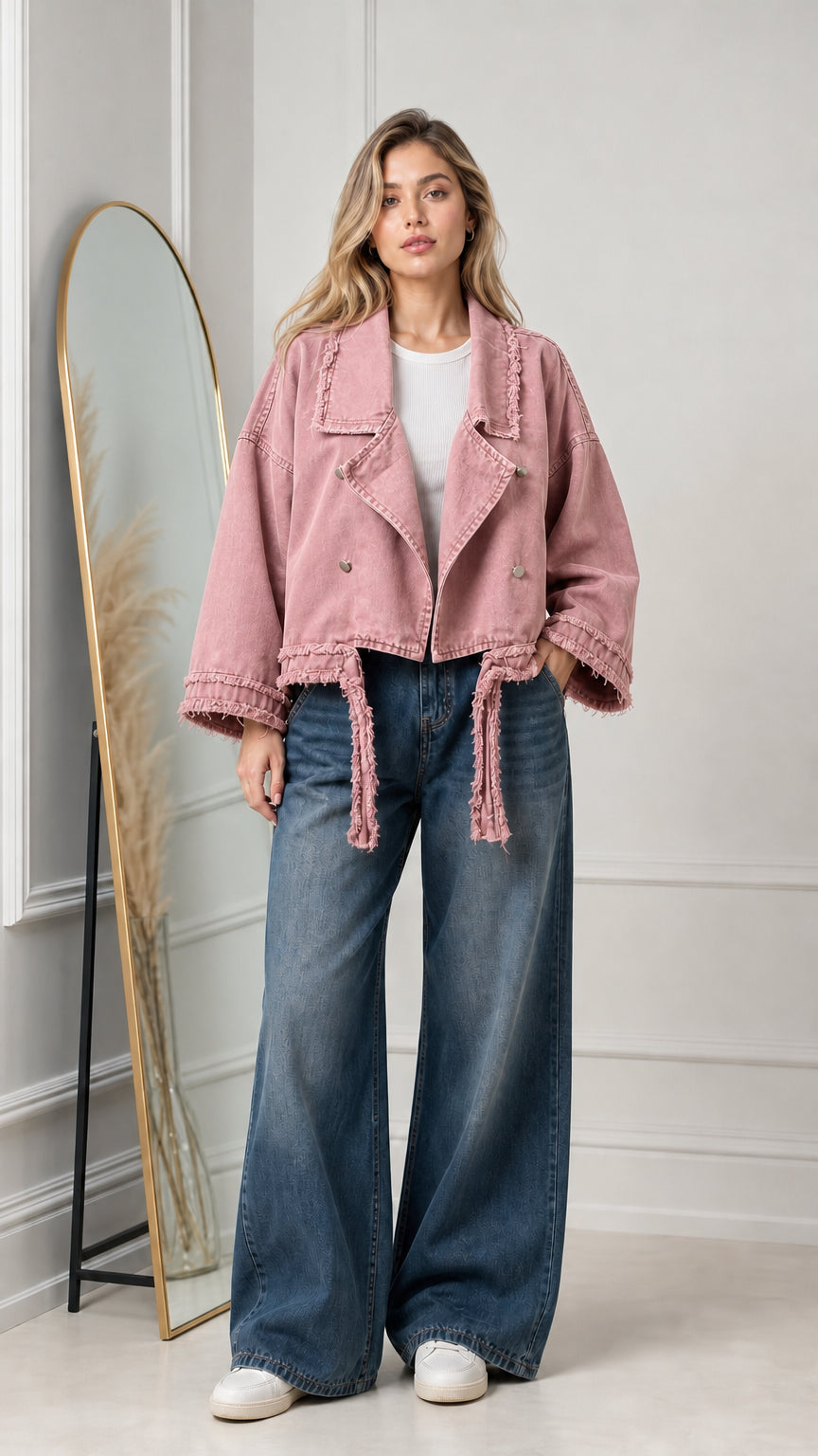 Model wearing dusty pink cropped raw-edge denim moto jacket