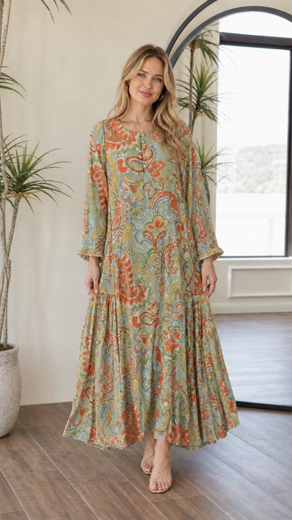 Front view of woman wearing sage green multi paisley print maxi dress