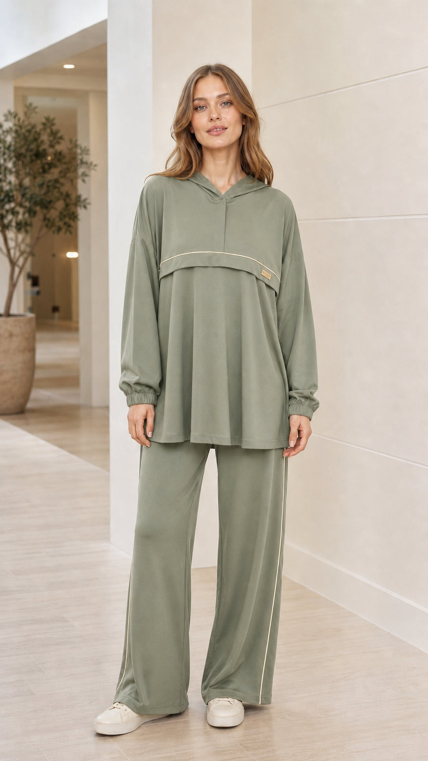 Front view of woman wearing sage green 2-piece hooded tunic and wide-leg pants loungewear set