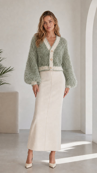 Model wearing sage green fluffy knit cropped cardigan with contrast trim