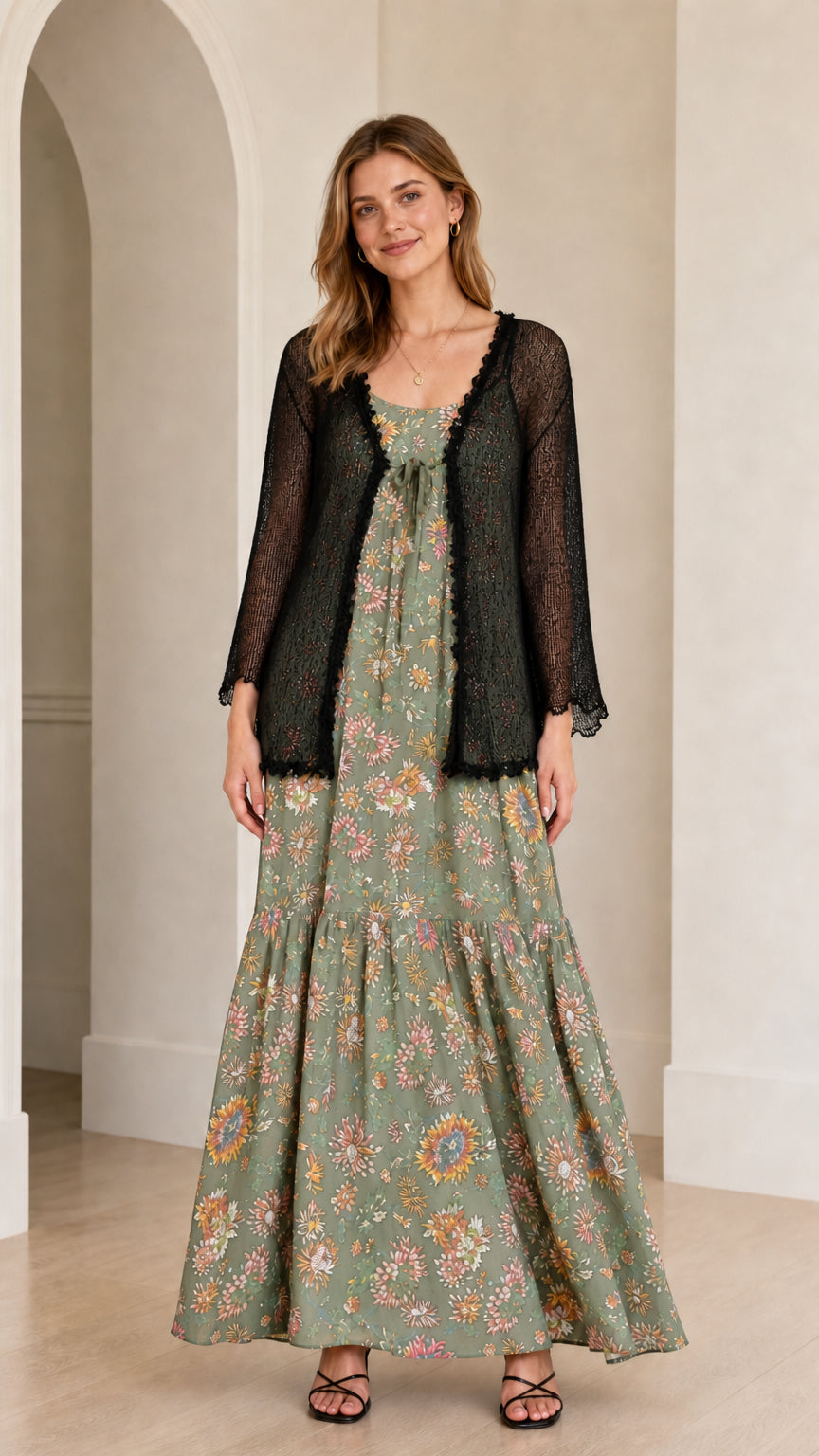 Front view of the sage green floral maxi dress with sheer black cardigan overlay