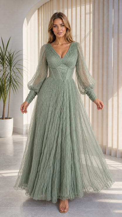 Front view of model wearing sage green pleated tulle gown with bishop sleeves