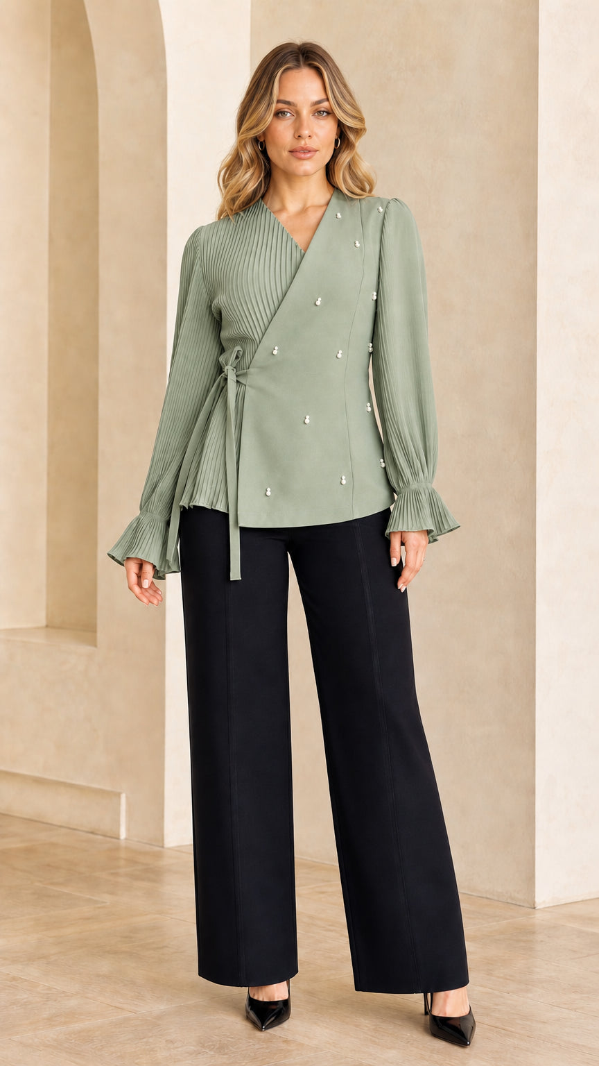 Model wearing sage green pleated tie-waist wrap blouse