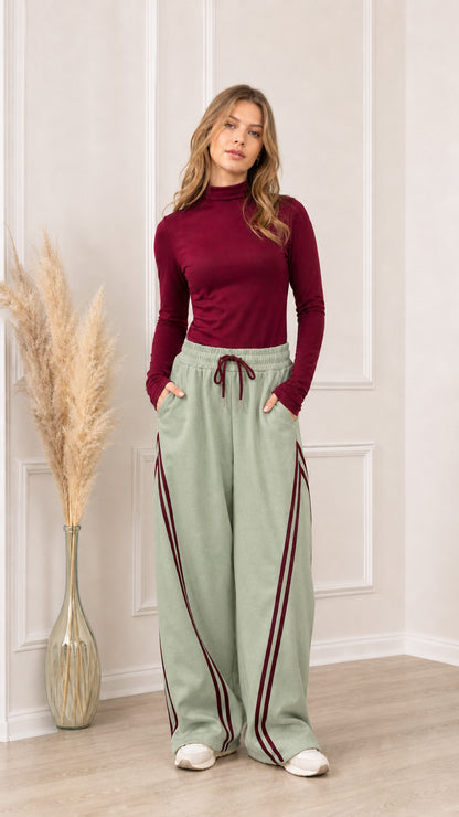 Full front view of sage green wide-leg sweatpants with burgundy side stripes