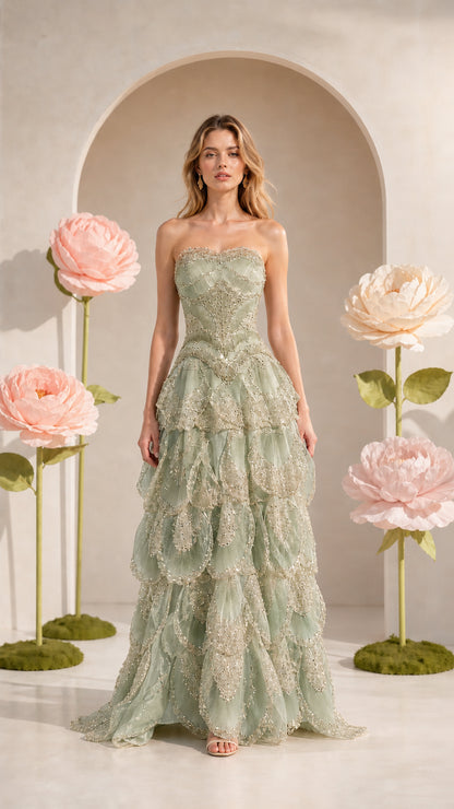Front view of strapless tiered formal gown in sage green