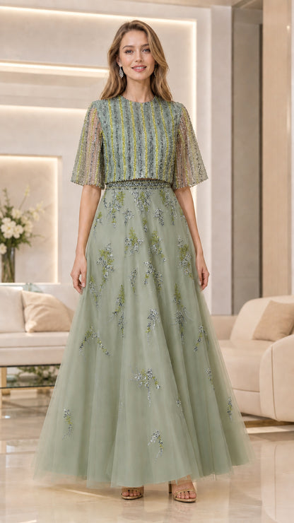 Model wearing sage green beaded flutter-sleeve tulle evening gown
