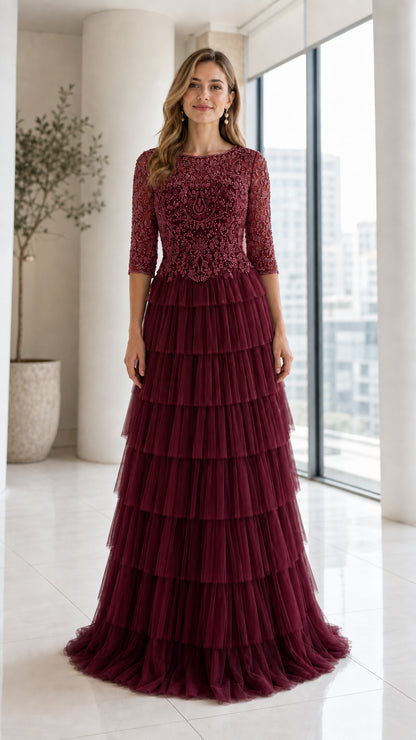 Front view of model wearing Burgundy beaded bodice tiered tulle evening gown