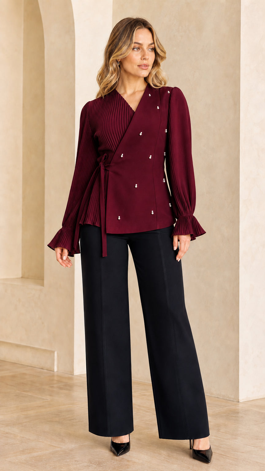 Model wearing burgundy red pleated pearl-embellished wrap blouse
