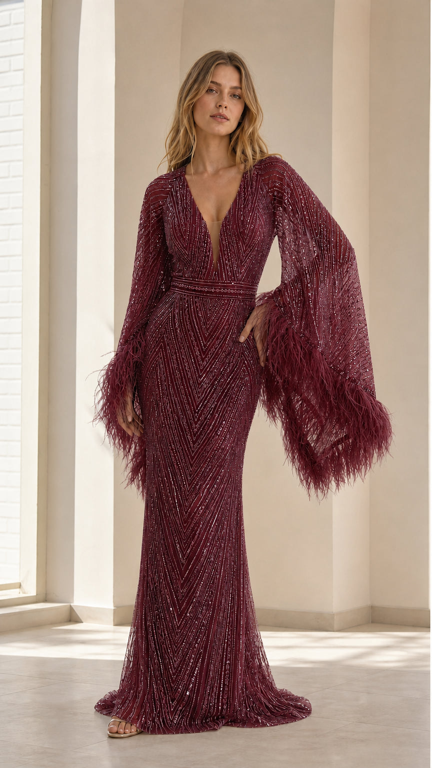 Front view of model wearing rich burgundy sequin evening gown with feather trim sleeves