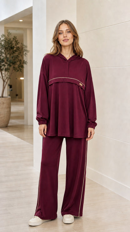 Front view of woman wearing burgundy 2-piece hooded tunic and wide-leg pants loungewear set