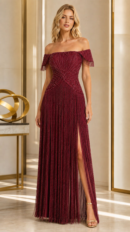 Model wearing burgundy red off-the-shoulder embellished fringe gown