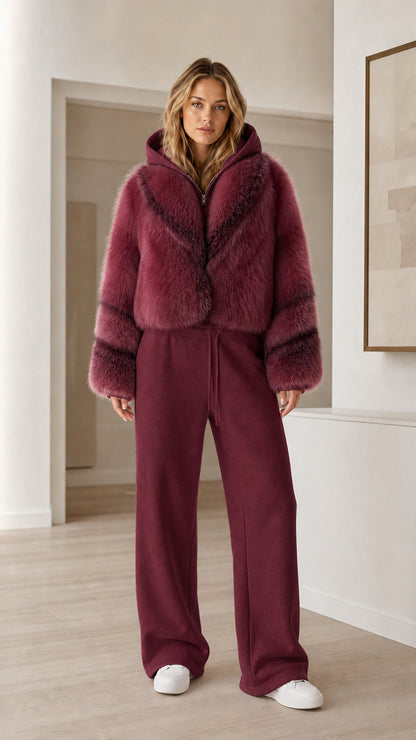 Model wearing rich burgundy cropped faux fur hooded jacket with wine colored sweatpants