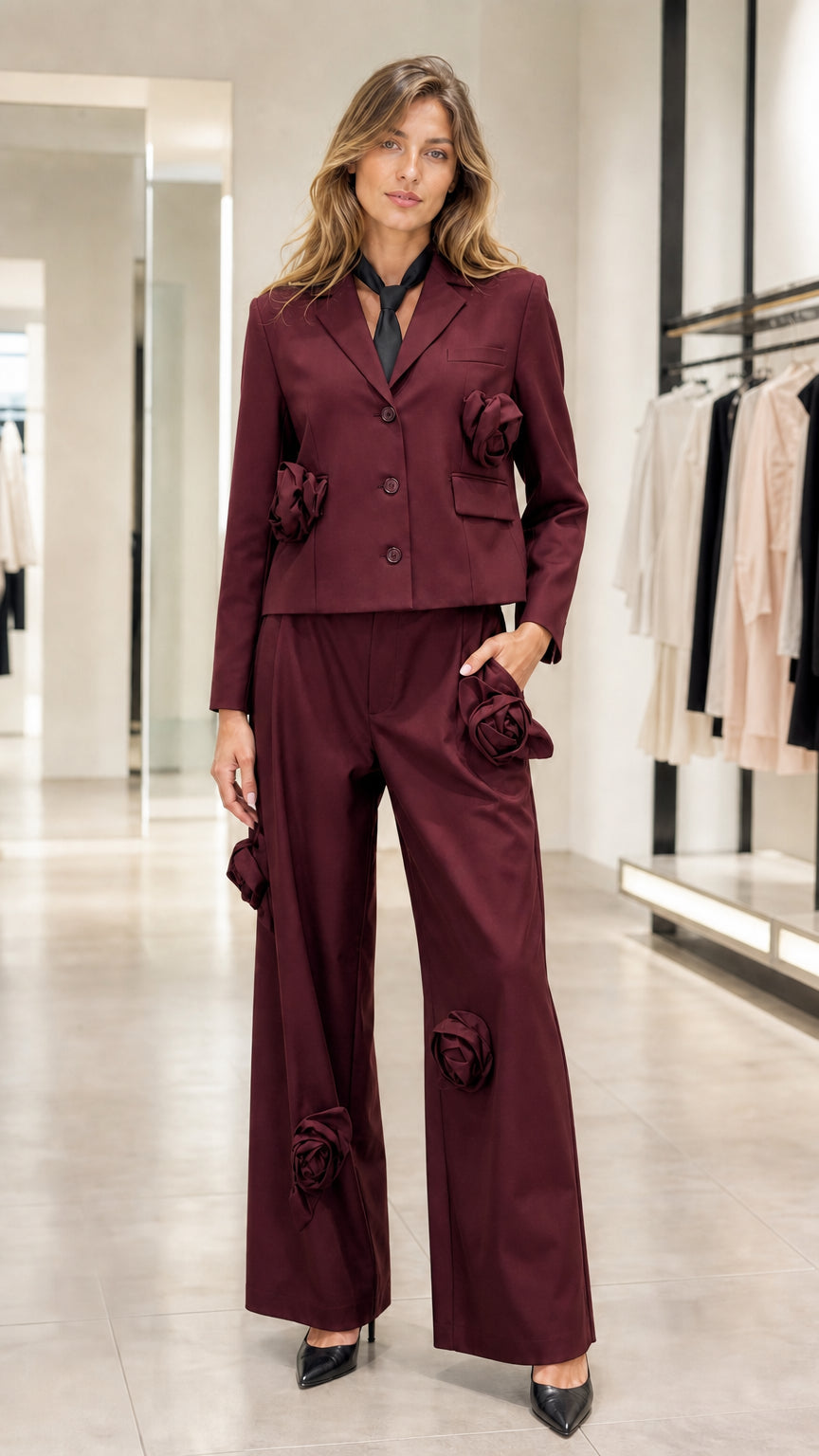 Model wearing burgundy wine red 3D floral blazer and wide-leg pant suit set