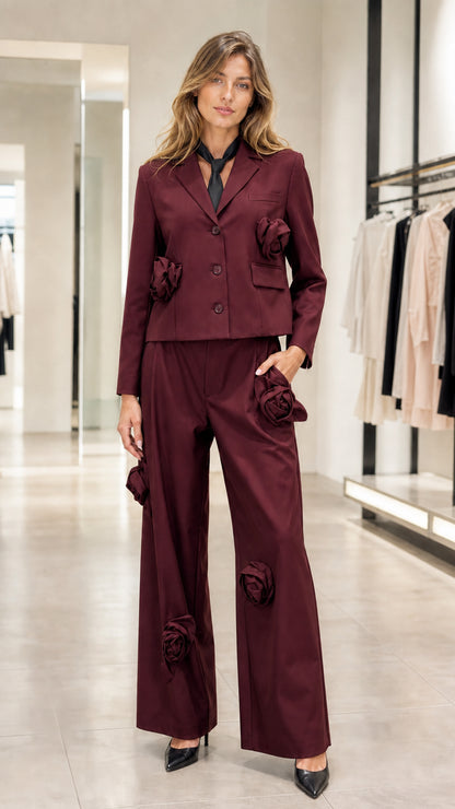 Model wearing burgundy wine red 3D floral blazer and wide-leg pant suit set