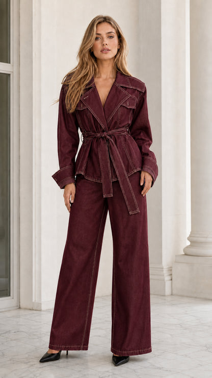 Model wearing burgundy red contrast stitch belted denim jacket and wide-leg pants set