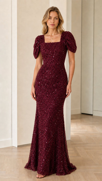 Front view of model wearing burgundy red sequin floor-length formal dress