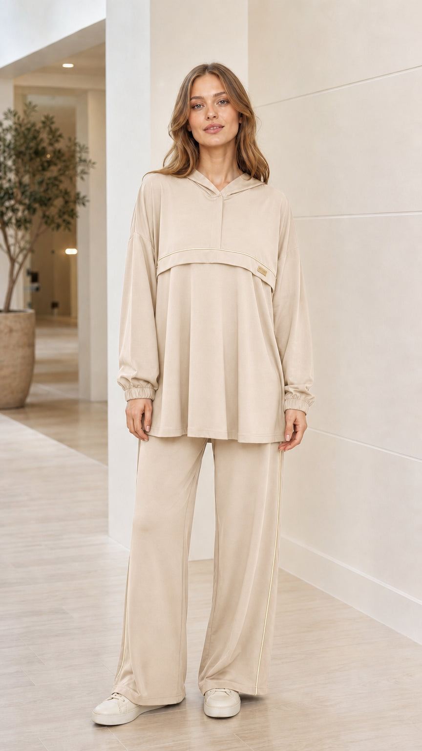 Front view of woman wearing beige cream 2-piece hooded tunic and wide-leg pants loungewear set