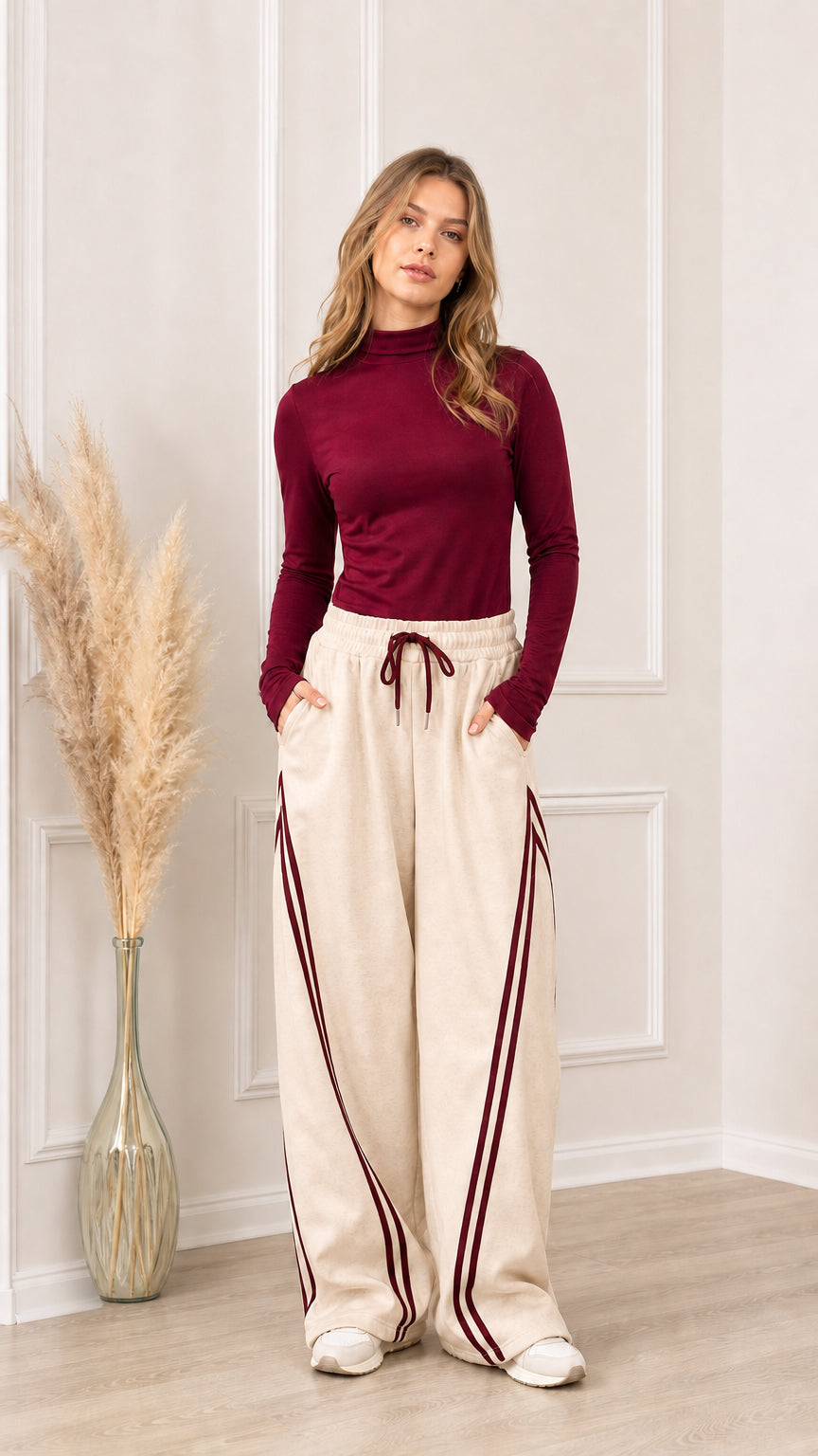 Full front view of beige wide-leg sweatpants with burgundy side stripes