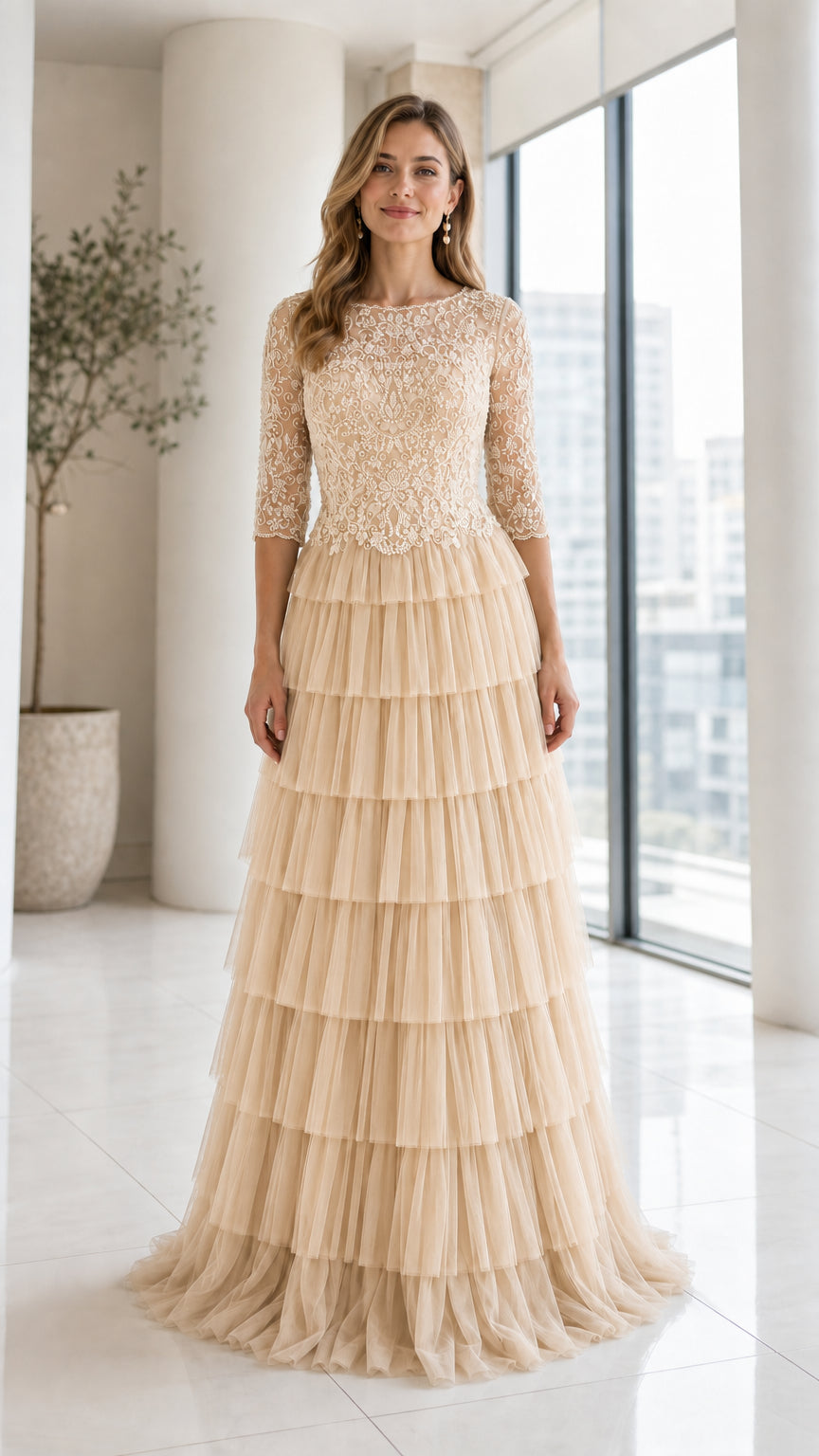 Front view of model wearing Champagne beaded bodice tiered tulle maxi gown