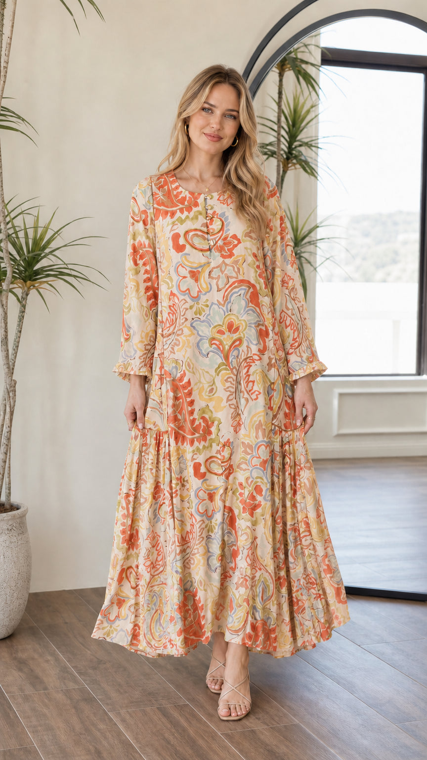 Front view of woman wearing warm yellow multi floral paisley tiered maxi dress