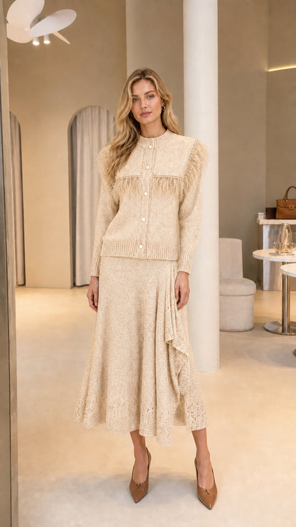 Full-length view of Cream beige feather trim knit cardigan and ruffled midi skirt set