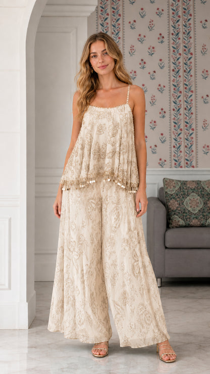 Model wearing champagne cream embroidered flowy two-piece palazzo pant set